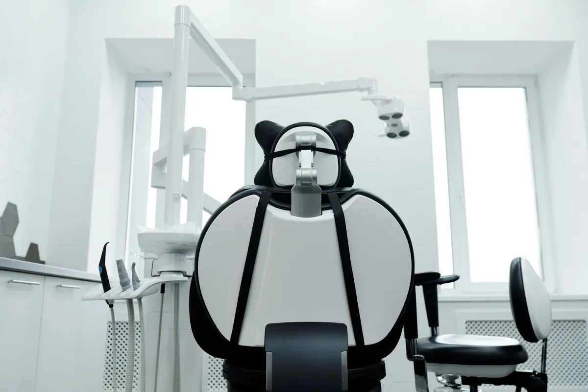 Modern dental chair and clinical equipment in a bright treatment room